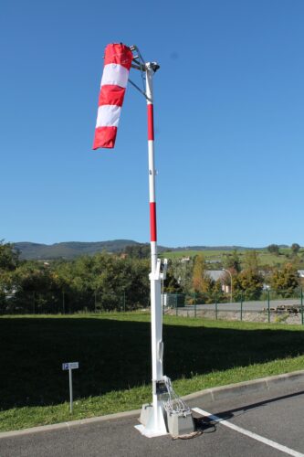Wind direction indicator installed on a concrete surface.